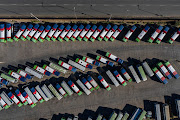 Buses in a parking lot in central Johannesburg during the initial stage of the Covid-19 lockdown, when public transport was not operating. 
