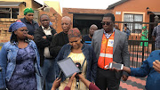 Acting social development MEC Panyaza Lesufi, right, visited the family of Ellen Mbhele in Soweto on Tuesday. Her granddaughter Phumzile Kheswa, centre, spoke to journalists on behalf of the family.