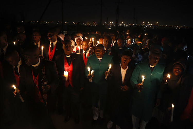 Various religious groups hold a vigil outside the tavern where 16 people were shot dead. Photo Thulani Mbele