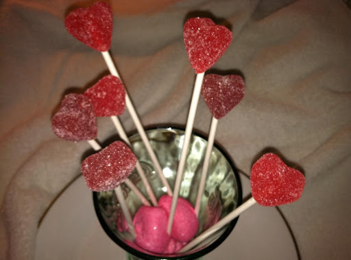 Dollar store Coke glass, Wilton sticks, jelly hearts and marshmallow hearts in bottom of glass.