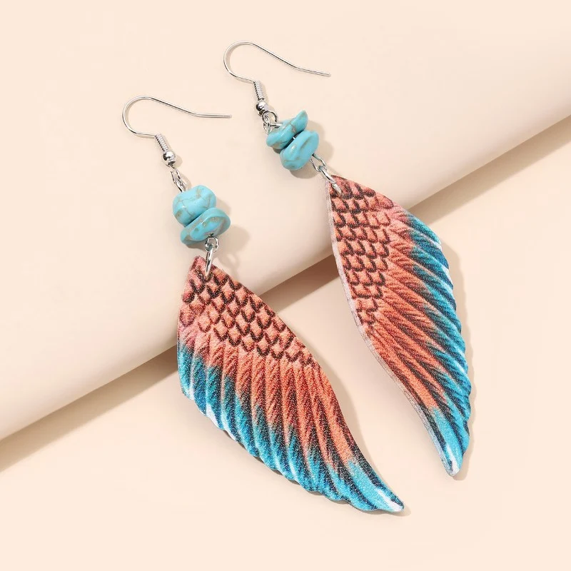 Boucles d'oreilles ailes d'ange en cuir bicolore. Élégance et style uniques pour femmes. Légères et sophistiquées. Le cadeau parfait pour sublimer votre look.