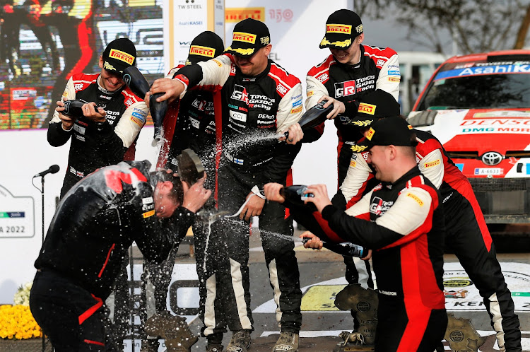 Toyota Gazoo Team (from L) Scott Martin (navigator), Elfyn Evans (Driver), Jonne Haltunen (navigator), Kalle Rovanpera (driver) Takamoto Katsuta (driver ) and Aaron Johnston celebrate sweeping the board during the World Rally Championship Safari Rally in Naivasha. June 26, 2022.