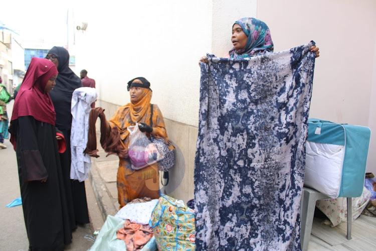 A vendor, Mariam Khaoya selling dera's to customers during the Eid Mubarak celebrations outside Jamia mosque, Nairobi on April 10, 2024