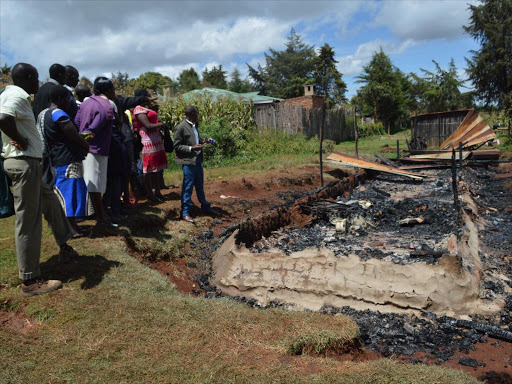 Residents look at the rubble of houses razed in Iten on Thursday October 12, 2017. /STEPHEN RUTTO