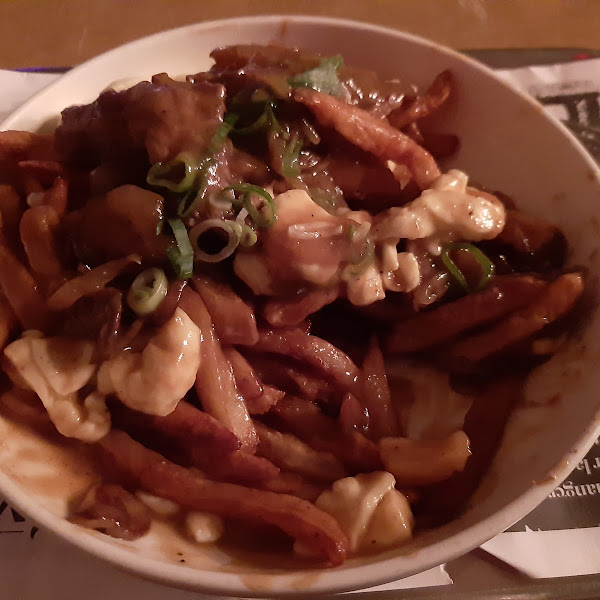 traditional poutine plus caramelized onions, meat and mushrooms