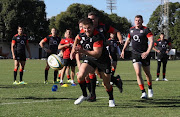 Denny Solomona picks up the loose ball watched by Owen Farrell during the England training session held at Kings Park Stadium on June 5, 2018 in Durban, South Africa. 