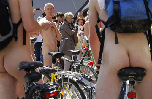 Pedestrians watch the World Naked Bike Ride in Brussels June 18, 2011. This annual manifestation is performed to demand more respect for cyclists on the streets and to promote the bike as an alternative non-polluting transportation vehicle. REUTERS/Francois Lenoir