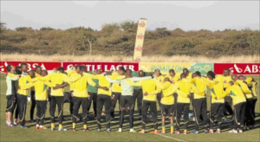 PRAYERS ANSWERED: Bafana Bafana in prayer as they take the fields for a training session at the Royal Bafokeng Sports Complex in Rustenburg, in the wake of the departure of coach Pitso Mosimane. Photo: SYDNEY SESHIBEDI