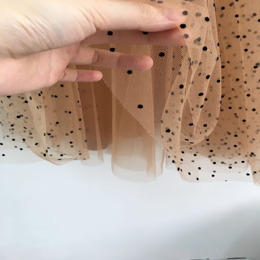 Title 4, Polka dot mesh skirt with an elastic high waist...