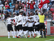 Tshegofatso Mabasa celebrates with teammates after scoring his second goal.   