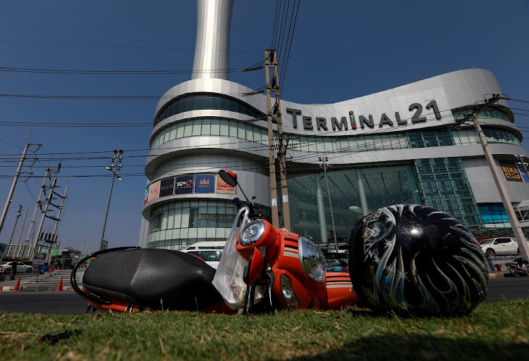 A motorcycle and helmet that belongs to a victim lie in front of the Terminal 21 shopping mall following a gun battle involving a Thai soldier on a shooting rampage, in Nakhon Ratchasima, Thailand February 9, 2020.