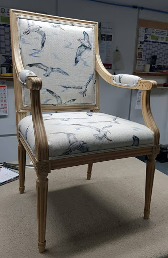 These two armchairs and scatter cushions have been re-upholstered by Terry and Lesley into seaside themed linen fabrics from studiog by Clarke & Clarke and finished with a double pipe.