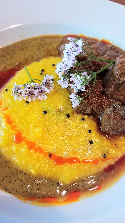 Aramsey Spiced Brunch with Ruchikala and Public Provisions: Rogan Josh, a spicy lamb curry. Here, the long simmered spicy lamb curry is combined with black cardamom, kashmiri chili oil, salt cured lemon coconut mustard polenta with yogurt, saffron, clove, nutmeg and other spices.