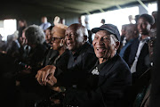 South African poet and writer Don Mattera, seated next to Welcome Msomi.