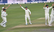 Quinton de Kock, Hashim Amla, Dean Elgar and Aiden Markram of the Proteas celebrate the wicket of Shan Masood of Pakistan during day 1 of the 3rd Castle Lager Test match between South Africa and Pakistan at Bidvest Wanderers Stadium on January 11 2018 