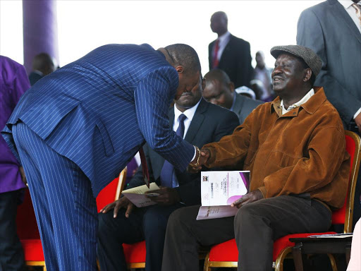 Nairobi Governor Mike Sonko (L) greets ODM Party leader Raila Odinga as COTU Secretary General Francis Atwoli looks on during the Labour Day celebrations at Uhuru Park. May 1, 2018. Photo/Jack Owuor