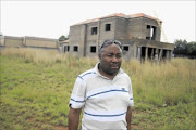 NOT FAIR: Isaac Motloung  says the land he has already paid for has been re-sold to another buyer who is  building this house on his property.
      Photo: Mabuti Kali
