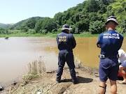 Police SAR members scour the Mvoti river in Glendale, north of Durban, where 8-year-old Nkosiyethu Gumede is believed to have drowned on Sunday while swimming with his father. His body has not yet been recovered 