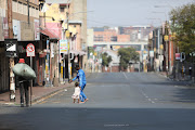 People walk through an unusually empty Johannesburg CBD on March 20 2023. Due to threats from the national shutdown, many businesses have closed their doors for the day. 