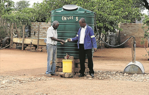 February 08, 2016. PAY TO QUENCH: John Manganyi pays Lesibana Senwamadi for water at their village outside Mokopane, Limpopo. Photo Sandile Nldovu. © Sowetan