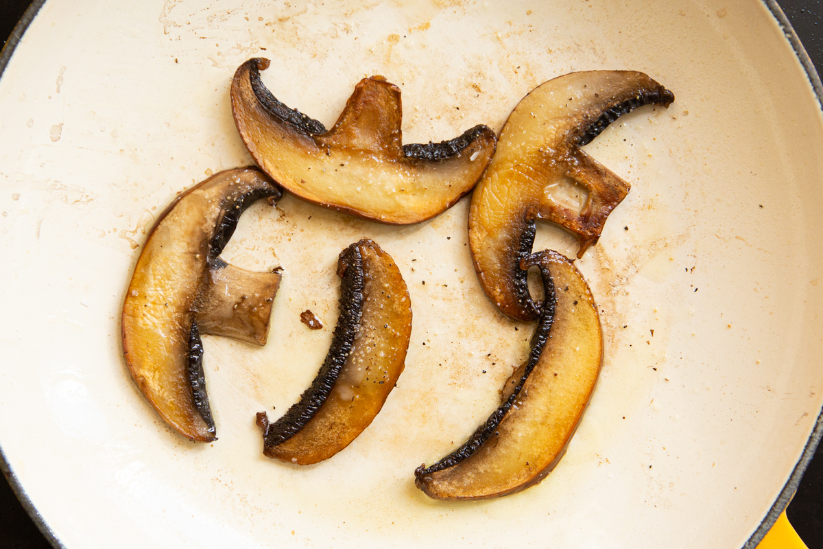 portobello mushroom cooking in a skillet