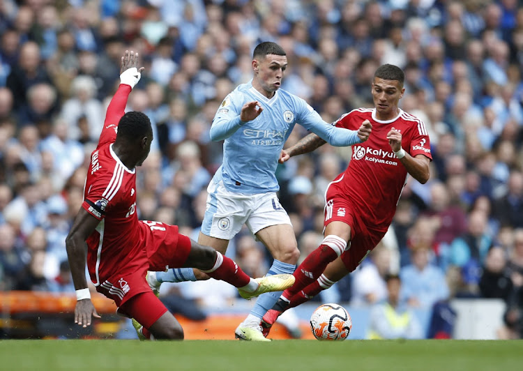 Manchester City's Phil Foden in action with Nottingham Forest's Moussa Niakhate and Nicolas Dominguez.