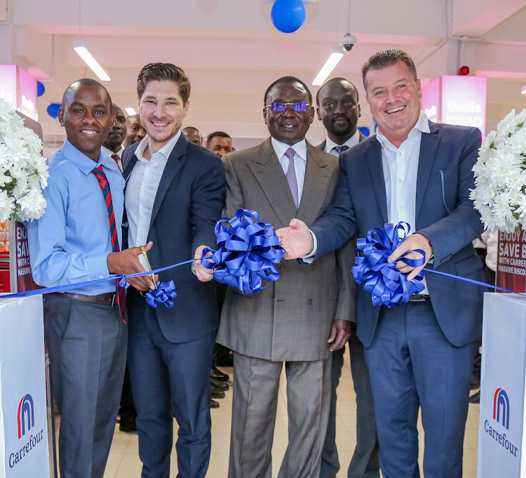 Carrefour store manager St Ellis Store Josephat Murimi, district manager Alexandre Cerqueira, Businessman Joshua Kulei, regional director Christophe Orcet, East Africa cut a ribbon to officially open Carrefour store St Ellis branch.