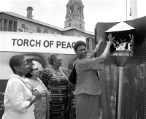 VIVA: Deputy Minister of Provincial and Local Government Nomatyala Hangana lights a torch of peace to symbolically kickstart the 16 Days of Activism against Women and Child Abuse in Tshwane yesterday. The campaign will officially start on November 25 and go on until December 10. It will focus on and highlight the abuse of women, children and men. With Hangana is Deputy Minister of Safety and Security Susan Shabangu, her foreign affairs counterpart Fatima Hajaig and the National Prosecuting Authority's Thoko Majokweni. 17/11/2008. © Unknown. Pic. Kendridge Mathabathe.