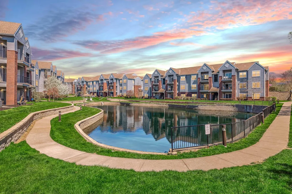 Peppertree Apartments community and pond at dusk