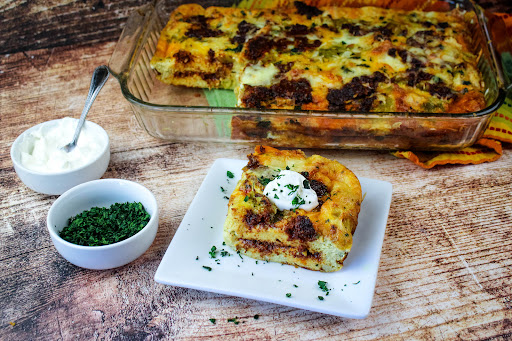 A slice of Southwestern Brunch Eggs with a dollop of sour cream.