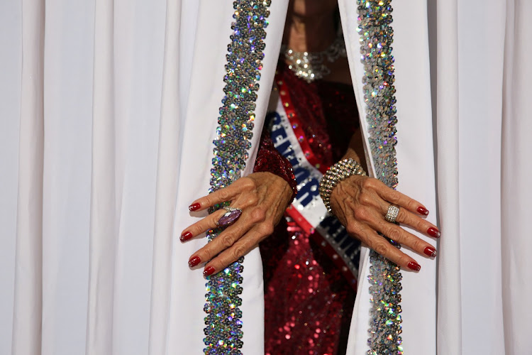 Debbie Carroll Boyce, Ms Senior America 2011, pulls back the curtains on the stage at the Ms Texas Senior America Pageant in Dallas.