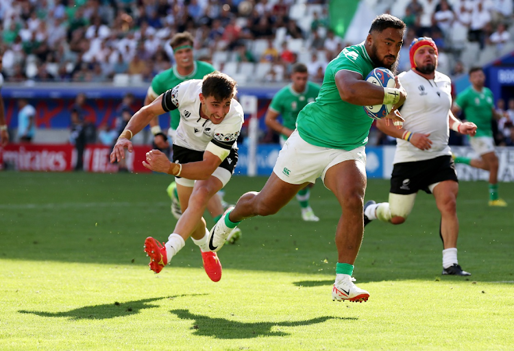 Bundee Aki of Ireland breaks through the Romania defence to score his side's eleventh try during the Rugby World Cup France 2023 match at Nouveau Stade de Bordeaux on September 09, 2023 in Bordeaux, France.