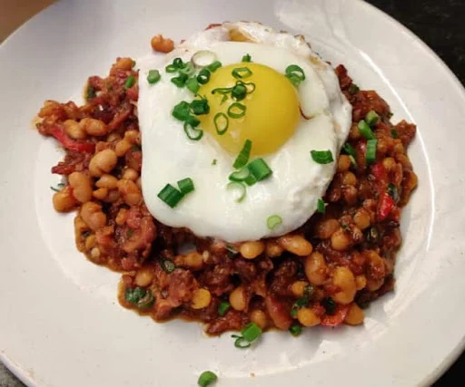 Porky Beans On Toast Topped With A Fried Egg