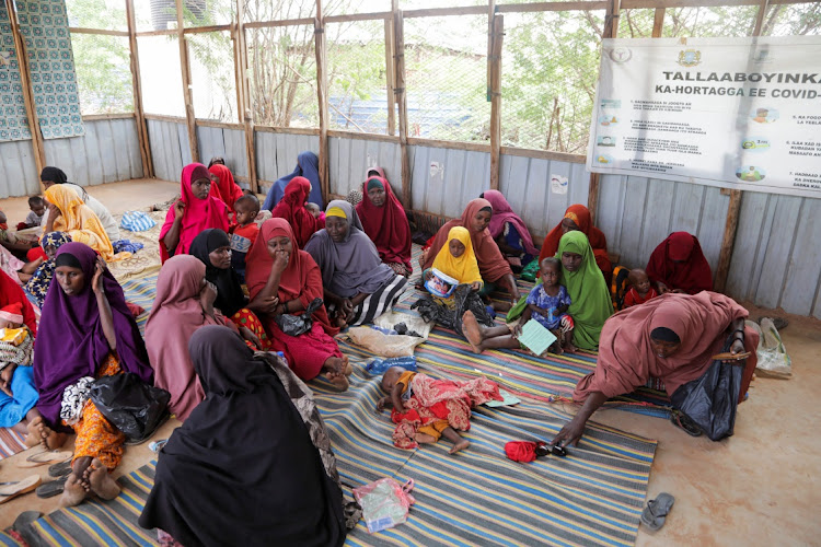 Internally displaced Somali women sit with their children as they wait for malnutrition screening at the Dollow hospital, in Dollow, Gedo Region, Somalia on May 24 2022. Picture: REUTERS/Feisal Omar