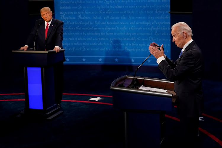 Democratic presidential candidate former Vice President Joe Biden answers a question as President Donald Trump listens during the second and final presidential debate at the Curb Event Center at Belmont University in Nashville, Tennessee, US, October 22, 2020.