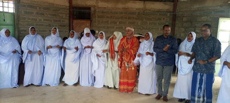 PS State department for Culture & Heritage Umi Bashir and Garissa Township MP Dekow Mohamed join Gargar dancers performing traditional song at the Garissa cultural center.