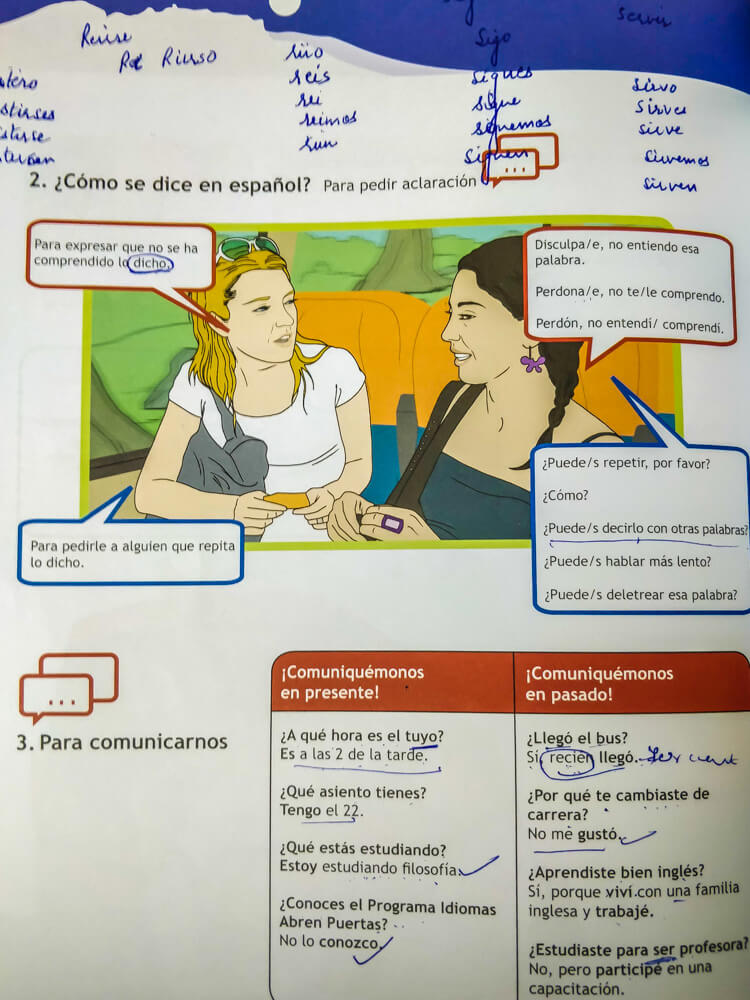 learning the most common spanish phrases for travelers from a Spanish workbook in Chile