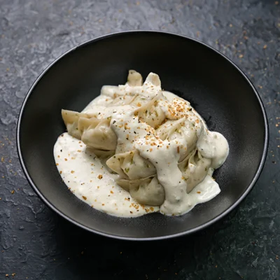 Paneer Momo In Molten Cheesy Sauce