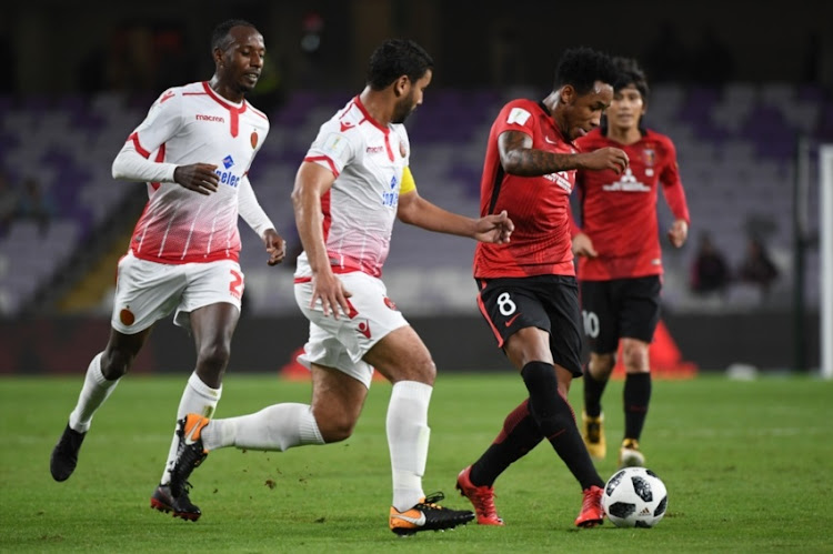 Rafael Silva of Urawa Reds passes the ball under the pressure from Youssef Rabeh of Wydad Casablanca on December 12, 2017 in Al Ain, United Arab Emirates.