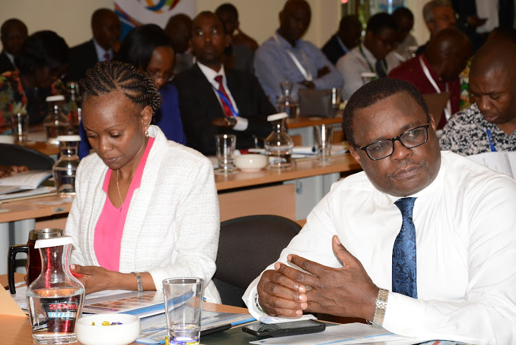 Kenya Private Sector Alliance CEO Carole Kariuki and Senate Speaker Ken Lusaka follow proceedings in Naivasha