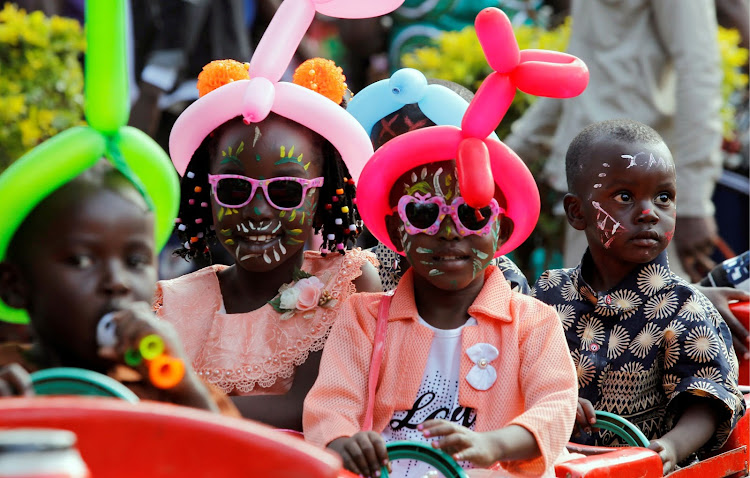 Children ride on a makeshift funfair train at the Uhuru Park grounds during Christmas Day celebrations in Nairobi, Kenya December 25, 2019.