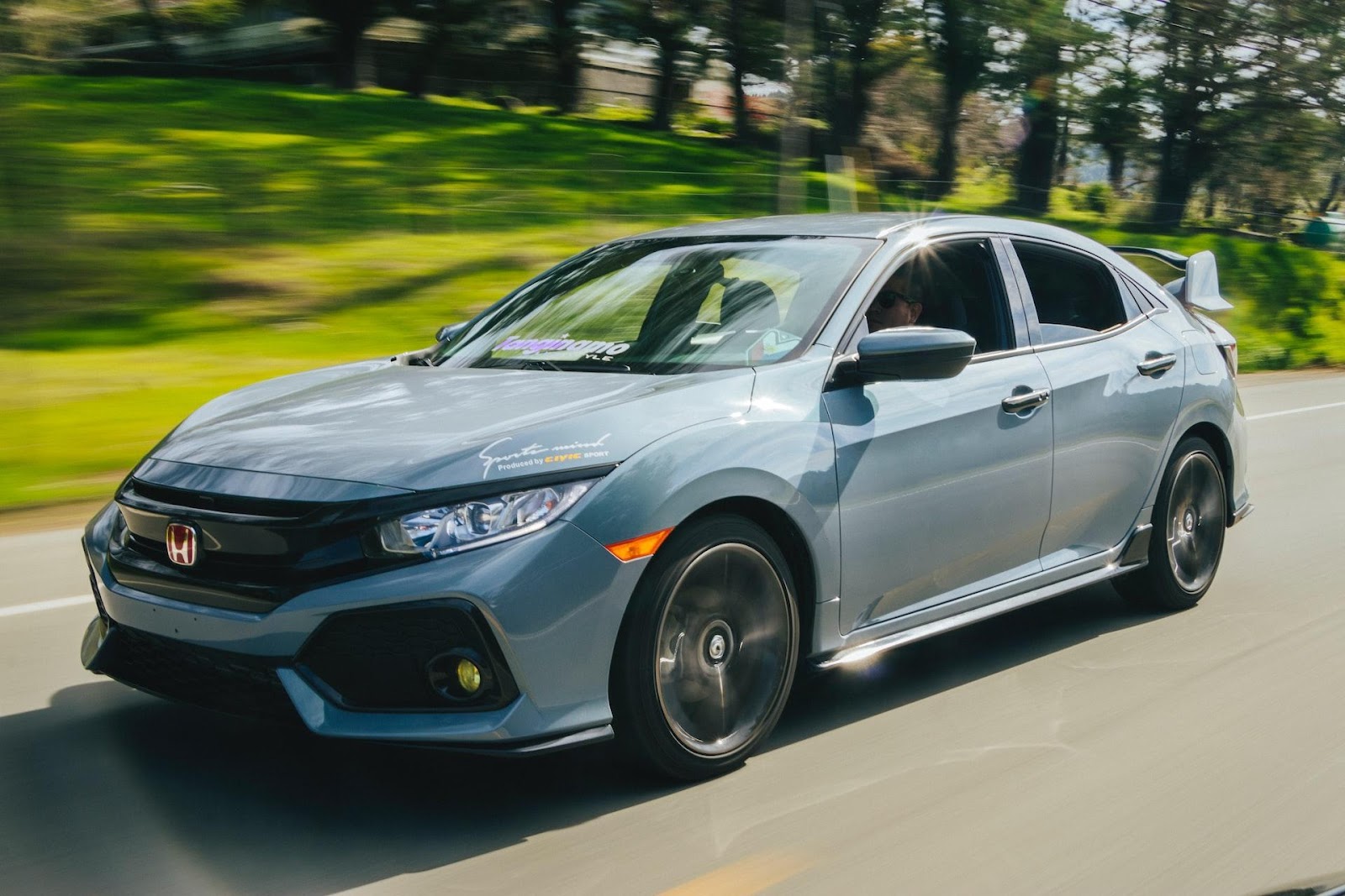 A picture of someone confidently driving their car down the road knowing that Red Shield Administration will help.