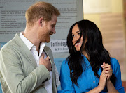 Prince Harry, Duke of Sussex, and his wife, Meghan, Duchess of Sussex, share a loving look during their visit to the District Six Museum on September 23 2019.