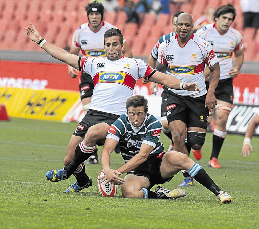 GOING DOWN: Kobus de Kock of the Lions and DuRandt Gerber of the Griquas during their Currie Cup match at Ellis Park yesterday. Picture: Gallo Images / Lee Warren