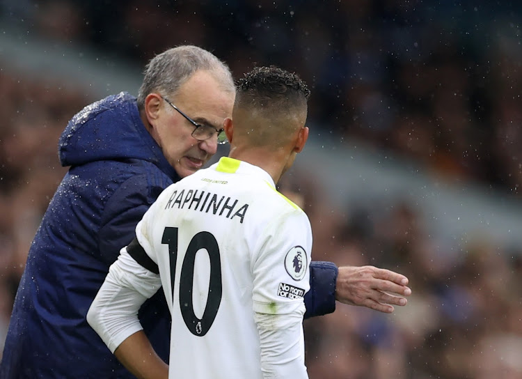 Leeds United's Raphinha speaks with his manager Marcelo Bielsa