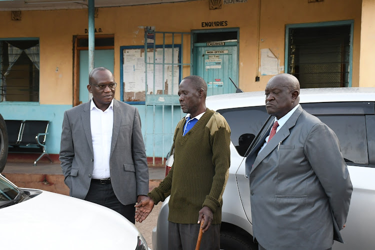 Deputy Governor Arthur Odera listens to one of the workers at the hospital.