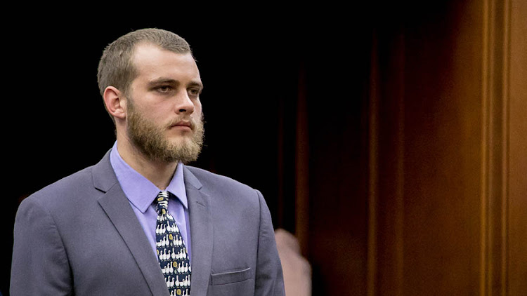 Henri van Breda stands to hear his sentencing in the Cape Town High Court. Van Breda received three life sentences after being found guilty of triple murder of his mother, father and brother.