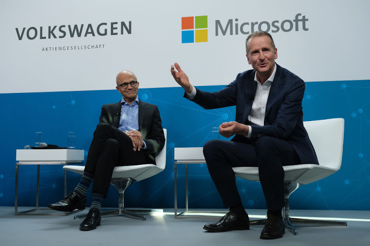 Herbert Diess (R), CEO of Volkswagen AG, and Satya Nadella, CEO of Microsoft, speak at a "fireside chat" to the media about a joint project between the two companies in Berlin, Germany. Microsoft is working with several automakers to advance the carmakers' digitalization.