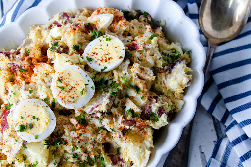 Nana JoAnn's Potato Salad with sliced egg and paprika on top.