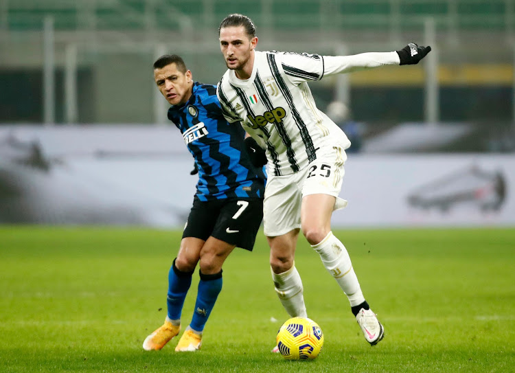 Inter Milan's Alexis Sanchez in action with Juventus' Adrien Rabiot